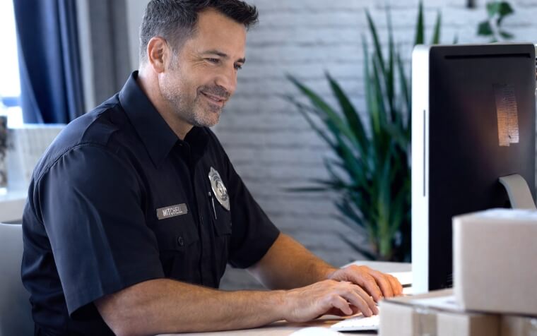 security company owner setting at a computer